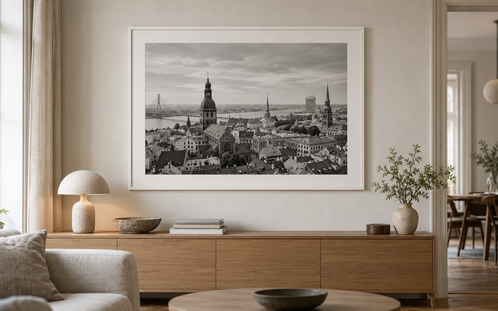 Riga rooftops print in a white frame on a living-room wall